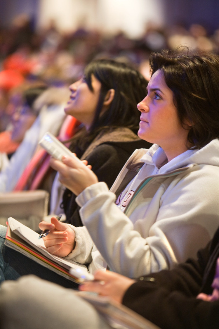 A student uses iClicker in a large lecture hall