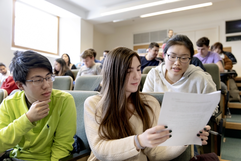 Three students read text together