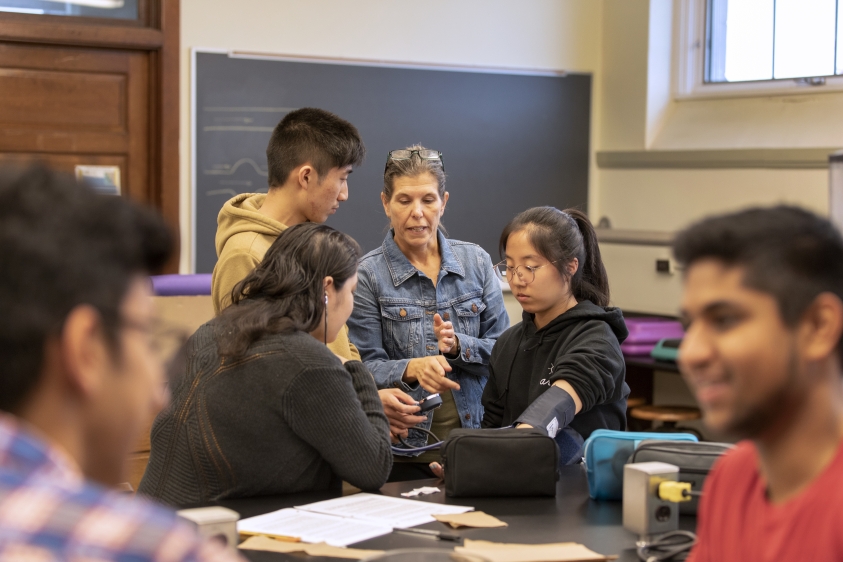 Sr. lecturer Darlene Campbell working with students in class