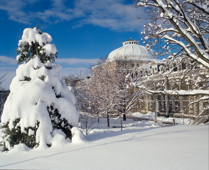 Sibley hall in winter with snow-covered trees