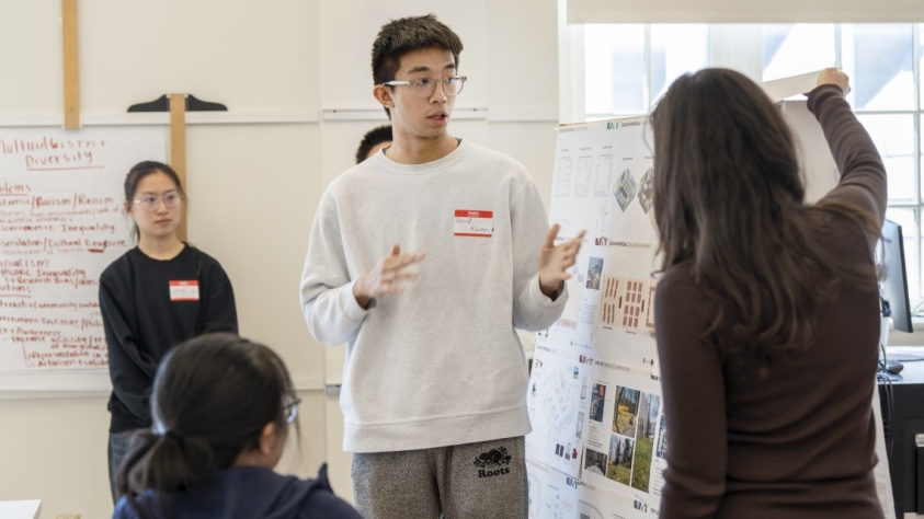 Two students giving a poster presentation