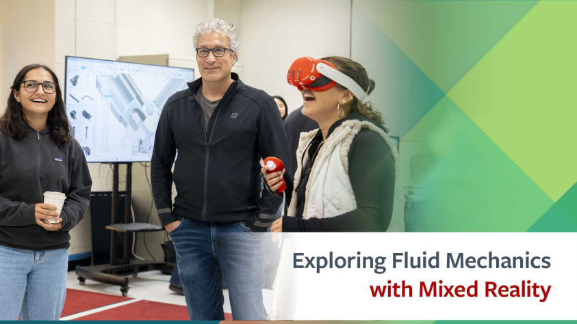 woman with VR headset in foreground, man and another student standing just behind her watching.