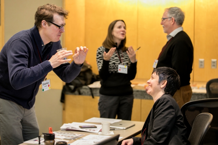 Four people talking during a professional development workshop