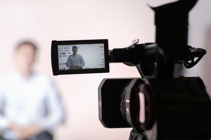 Faculty being filmed on camera