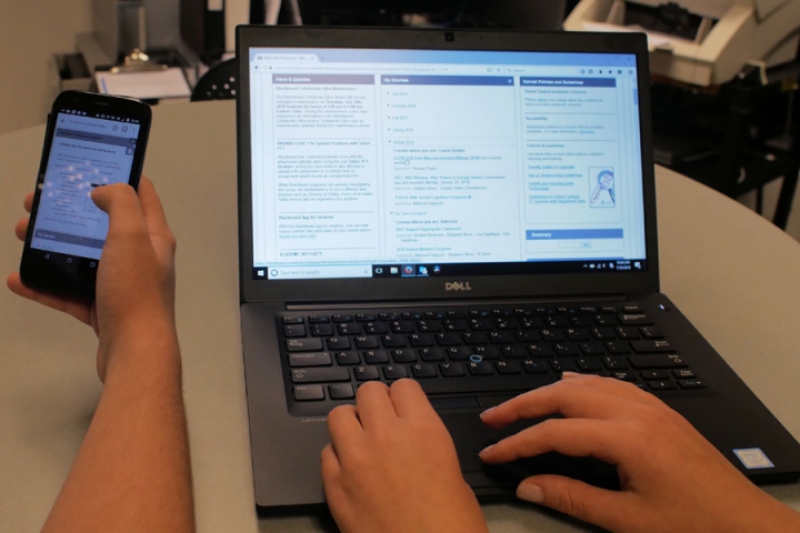 Students accessing Blackboard on their mobile phone and laptop devices.