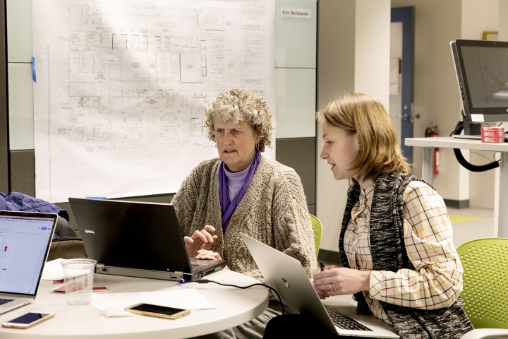 Two instructors working together on computers