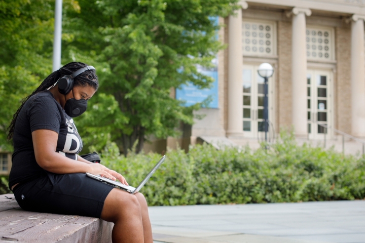 Woman working on computer outside