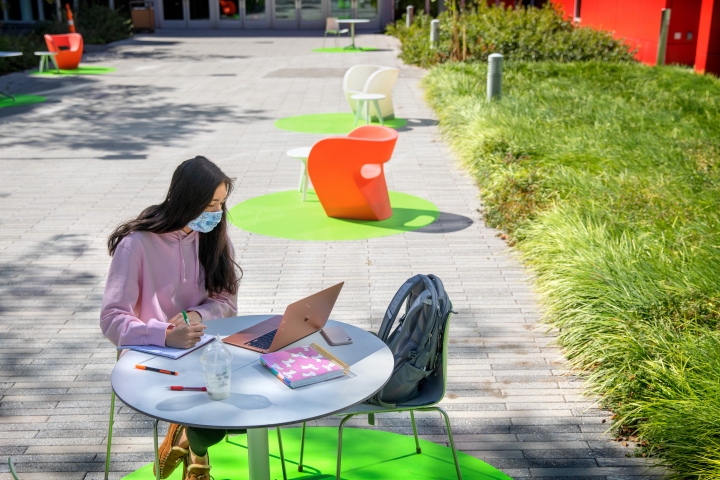 Student studying at outdoor table