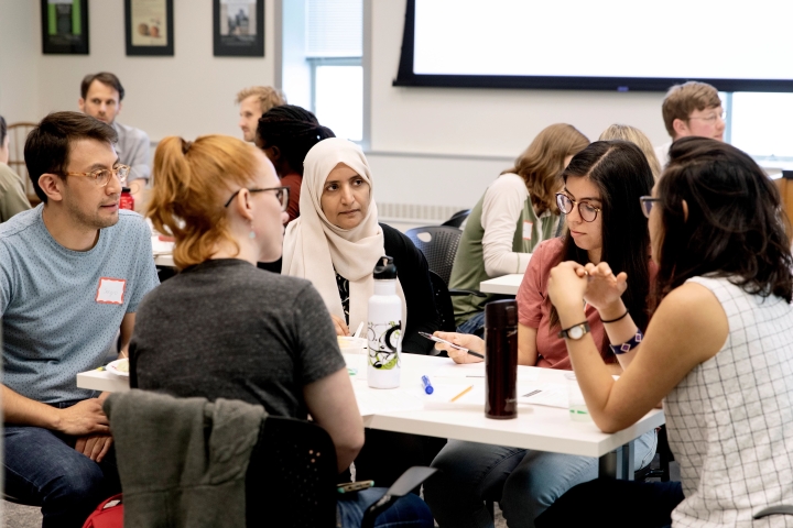 group of TAs sitting around a table having a discussion