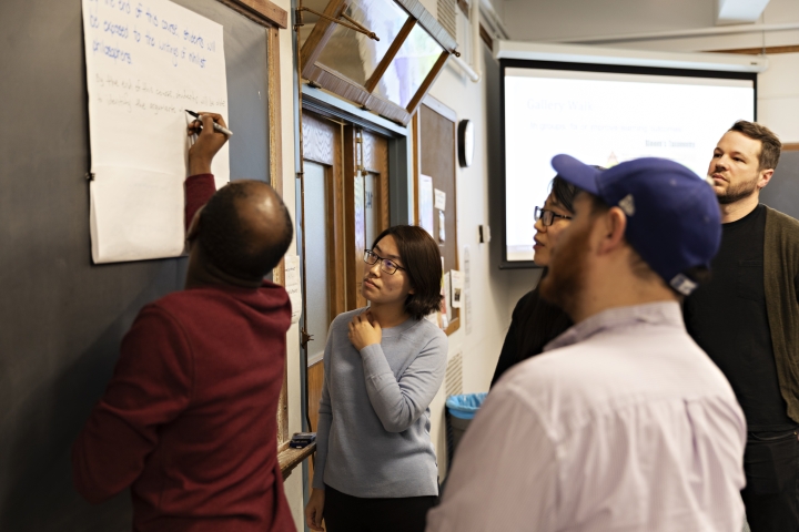 A group of students working at a whiteboard