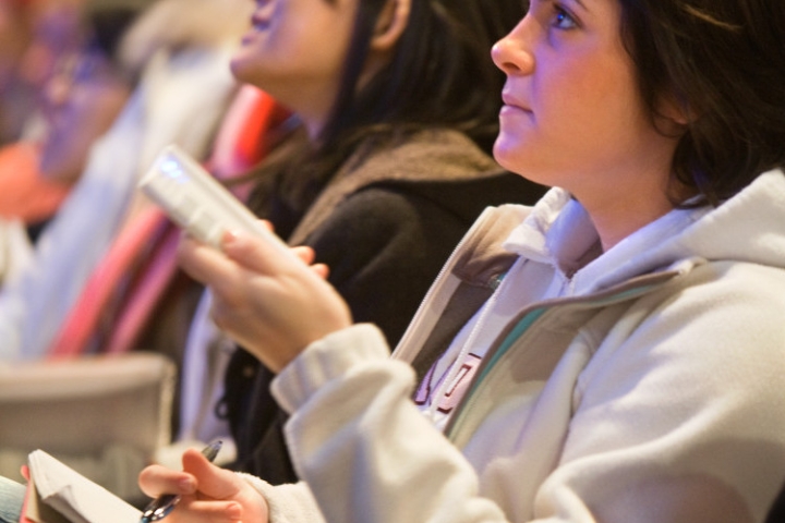 A student uses iClicker in a large lecture hall