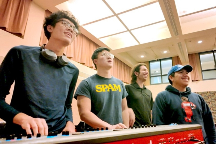 four students at a music keyboard