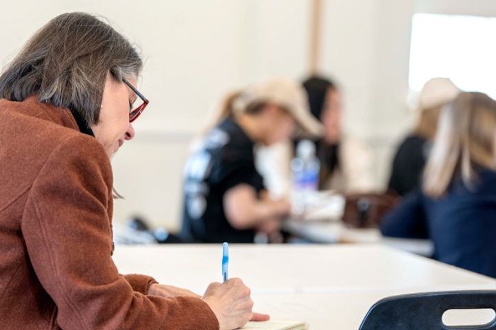 A CTI observer takes notes during a classroom observation.