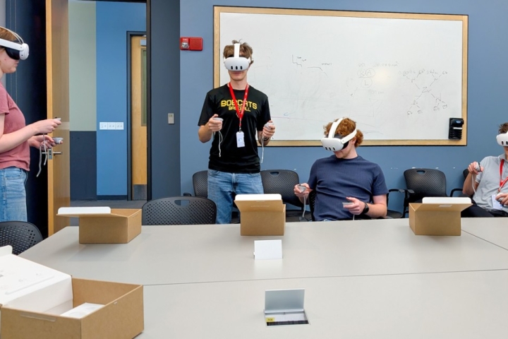 Students practice with VR headsets in a classroom