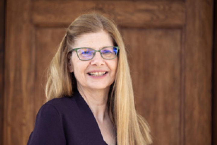 Headshot of Dr. Susan Singer, a woman with long blonde hair and green glasses