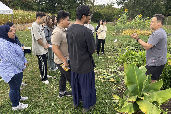 students in a garden learning from an instructor